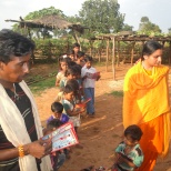 Distributing books in the school started by Sacred Association in Simariya Village