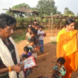 Distributing books in the school started by Sacred Association in Simariya Village
